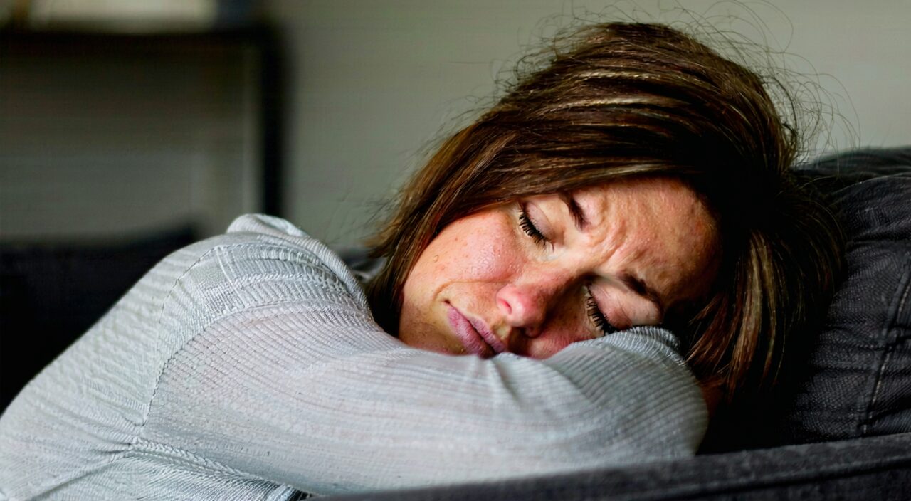 A person resting at home with heavy head, fatigue, and chills without sweating, indicating a scenario where Xiang Ru San might be suitable