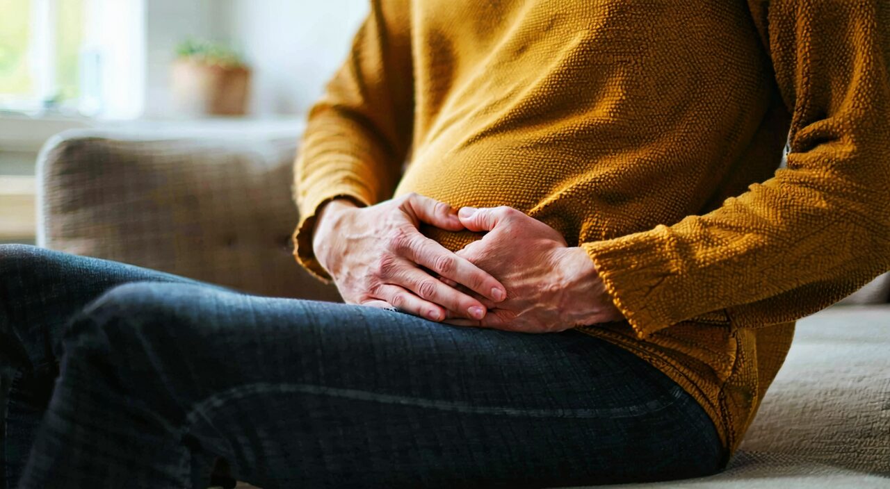 Scene of a person holding their stomach when feeling discomfort