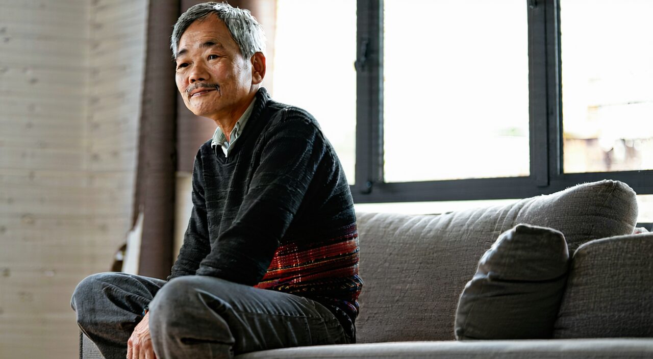 A person experiencing soreness and weakness in the lower back and knees resting at home