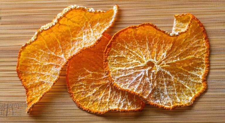 Close-up of the orange-red exterior and yellowish-white inner surface of dried tangerine peel
